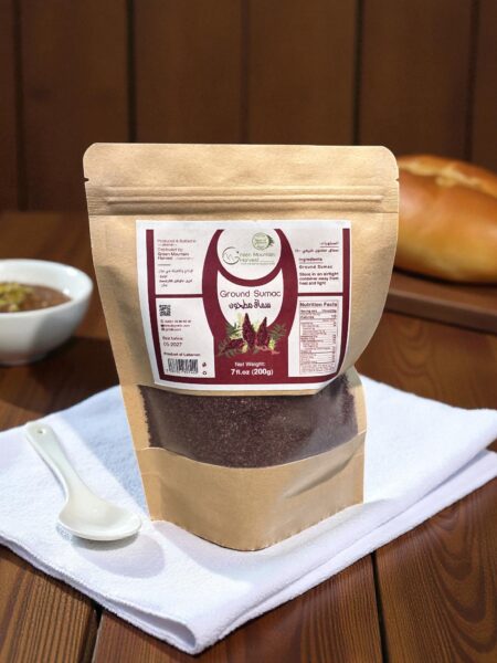 A bag of sumac placed on a white towel on a wooden table